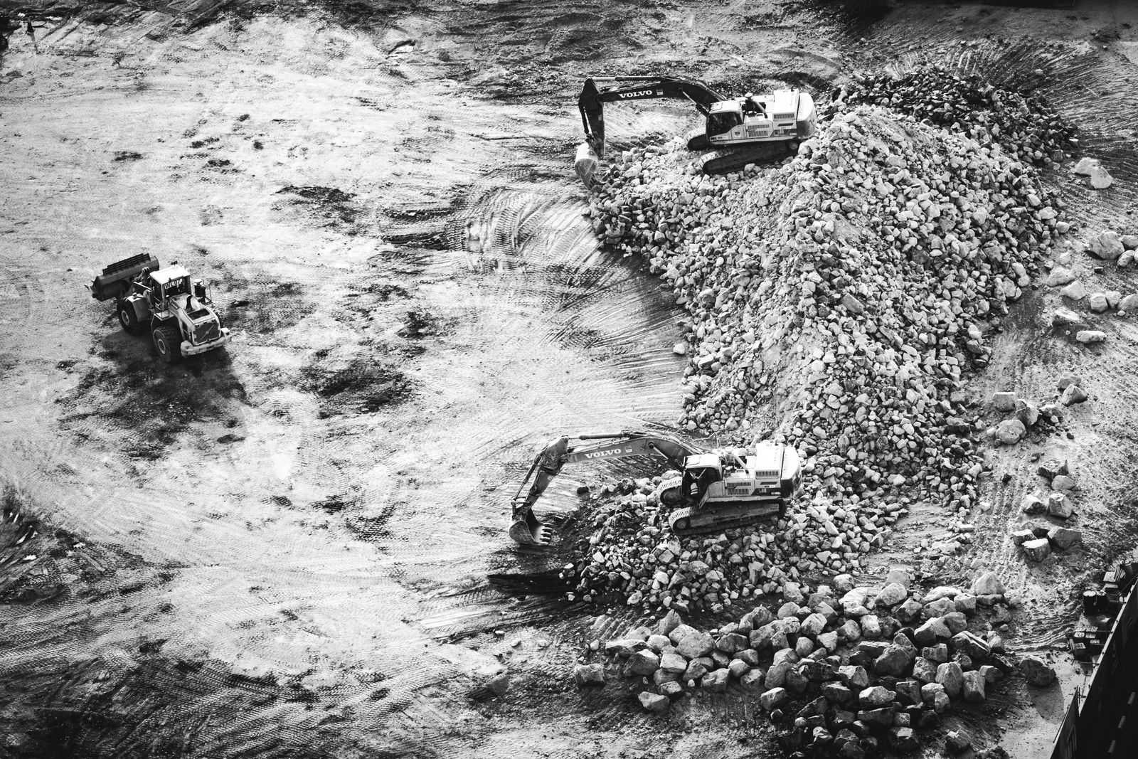 Excavators working a rock pile